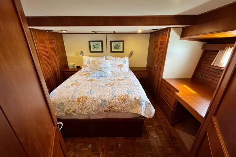 Slide: The Image of Luxurious cabin interior of 2000 Grand Banks 52 Europa yacht with cozy bed and wooden furnishings. - 25