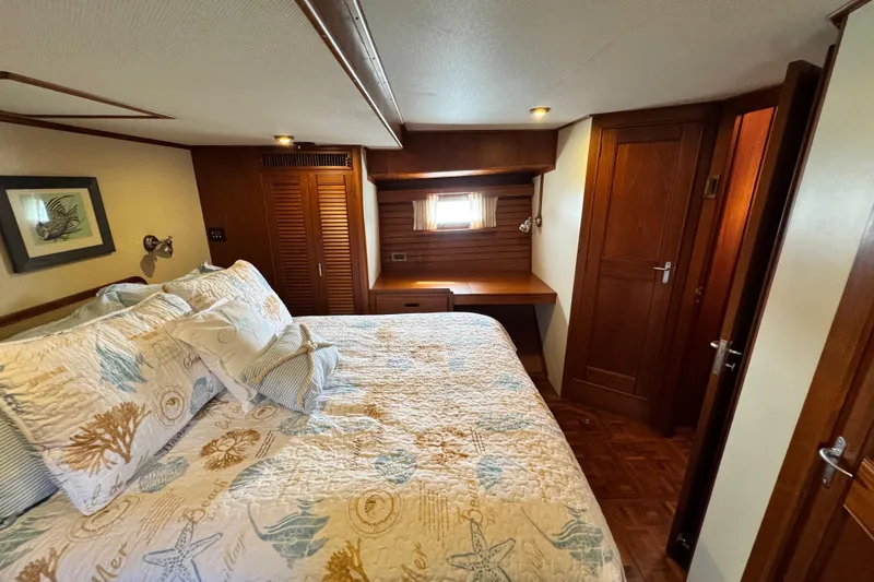 Slide: The Image of Luxurious cabin interior of 2000 Grand Banks 52 Europa yacht with cozy bedding and wooden decor. - 28