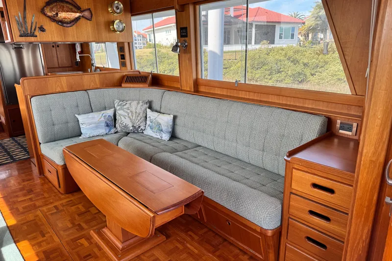 Slide: The Image of Luxurious interior of 2000 Grand Banks 52 Europa yacht with elegant wood finish and cozy seating. - 3