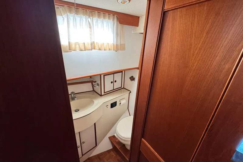 Slide: The Image of Bathroom interior of 2000 Grand Banks 52 Europa yacht with wood paneling and compact design. - 35
