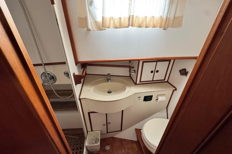 Slide: The Image of Bathroom interior of 2000 Grand Banks 52 Europa yacht with sink, toilet, and shower. - 39