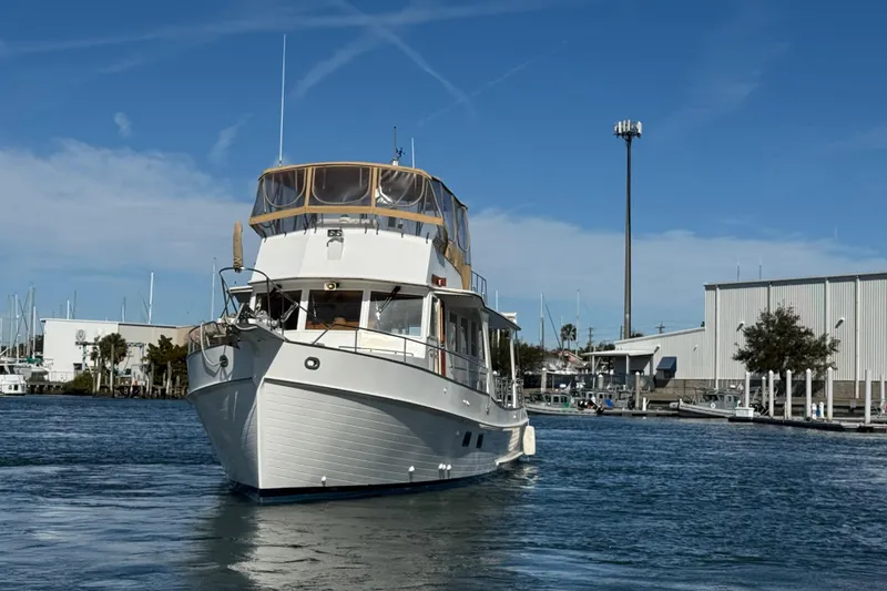 Slide: The Image of Grand Banks 52 Europa yacht from 2000 on calm waters near a marina. - 4