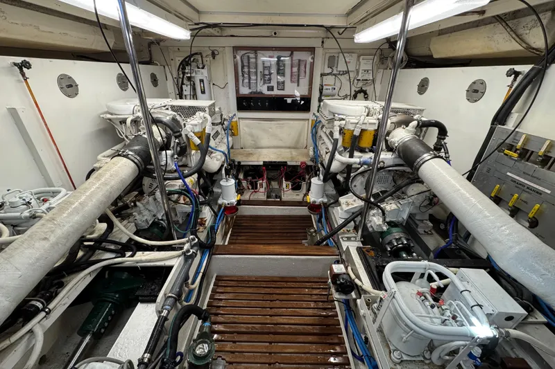 Slide: The Image of Engine room of 2000 Grand Banks 52 Europa yacht, showcasing dual engines and mechanical systems. - 45