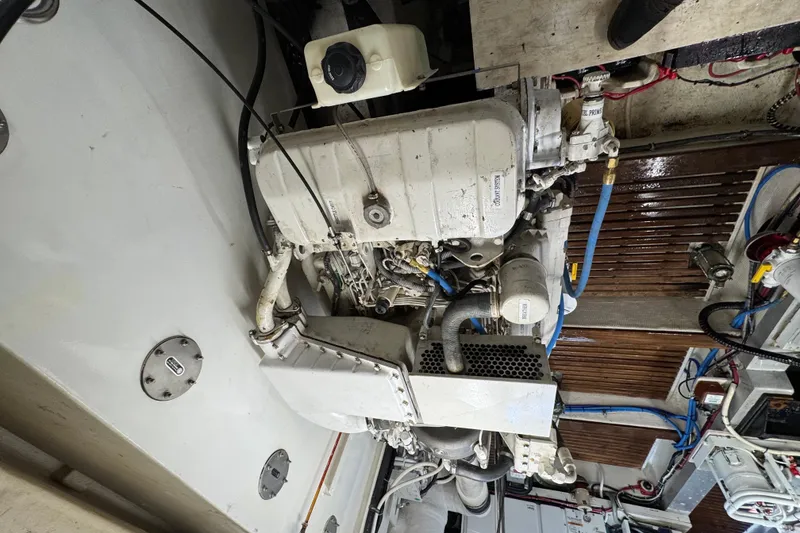 Slide: The Image of Engine room of 2000 Grand Banks 52 Europa yacht, showcasing mechanical components and systems. - 47