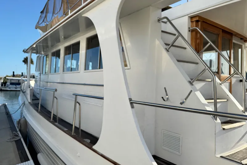 Slide: The Image of Grand Banks 52 Europa yacht, 2000 model, docked with visible stairs and railing. - 51