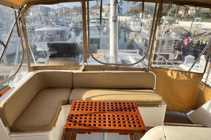 Slide: The Image of Interior view of 2000 Grand Banks 52 Europa yacht with seating and marina backdrop. - 53