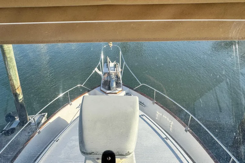 Slide: The Image of Bow view of 2000 Grand Banks 52 Europa yacht on calm water. - 58