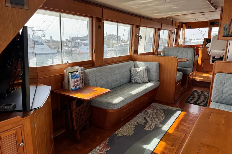 Slide: The Image of Interior of 2000 Grand Banks 52 Europa yacht with elegant wood finish and comfortable seating. - 6