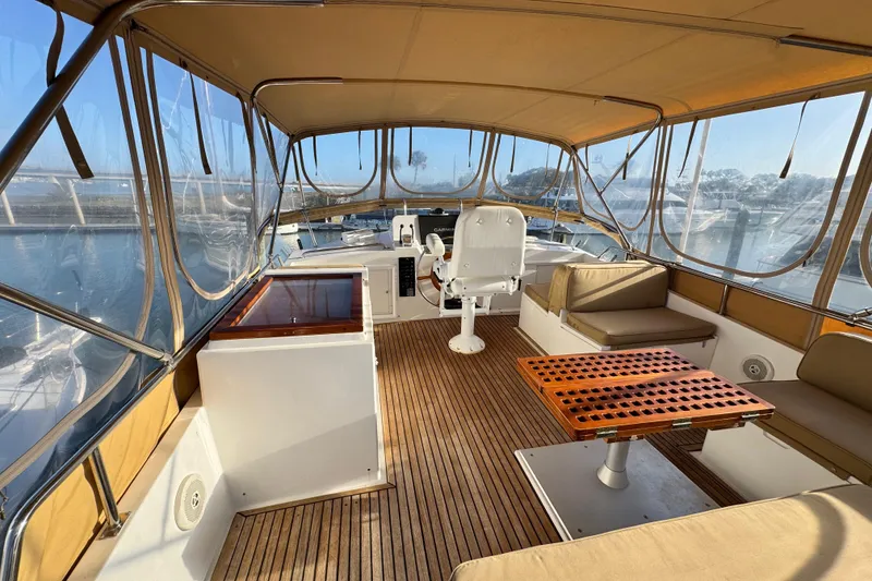 Slide: The Image of Spacious interior of 2000 Grand Banks 52 Europa yacht with seating and helm station. - 64