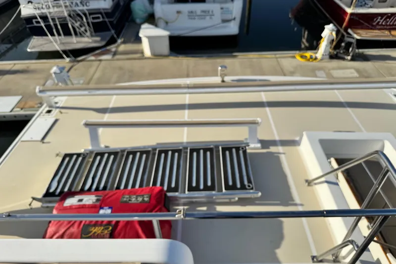 Slide: The Image of Deck of 2000 Grand Banks 52 Europa yacht with red life jacket and railing. - 67