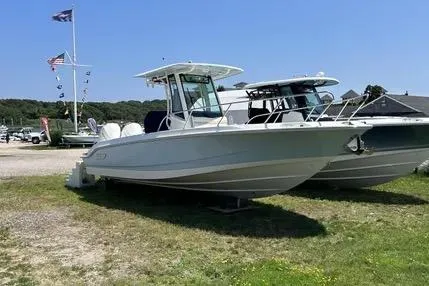 The Image of 2023 Boston Whaler 280 Dauntless boat displayed outdoors on grassy area. - 0