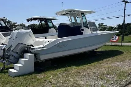 Slide: The Image of 2023 Boston Whaler 280 Dauntless boat displayed outdoors on grass. - 1