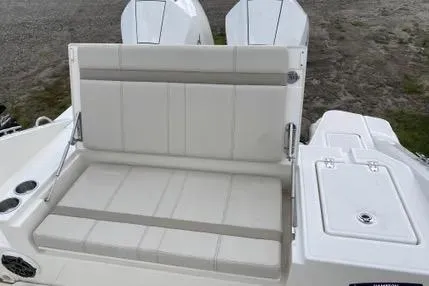 Slide: The Image of 2023 Boston Whaler 280 Dauntless boat with cushioned seating and dual engines. - 10