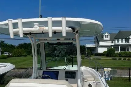 Slide: The Image of 2023 Boston Whaler 280 Dauntless boat with T-top and console, parked near residential area. - 15