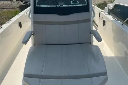 Slide: The Image of 2023 Boston Whaler 280 Dauntless boat interior with cushioned seating and armrests. - 18