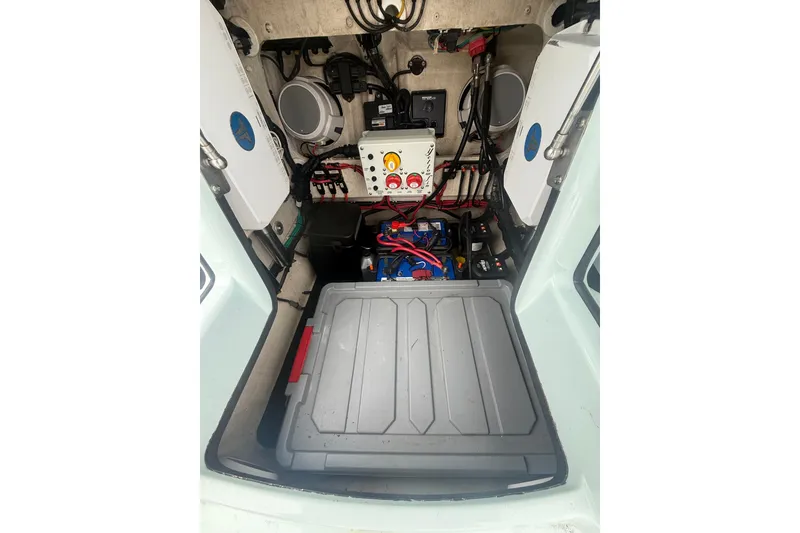 Slide: The Image of 2020 Yellowfin 24 Bay CE boat interior showing electrical components and storage area. - 6
