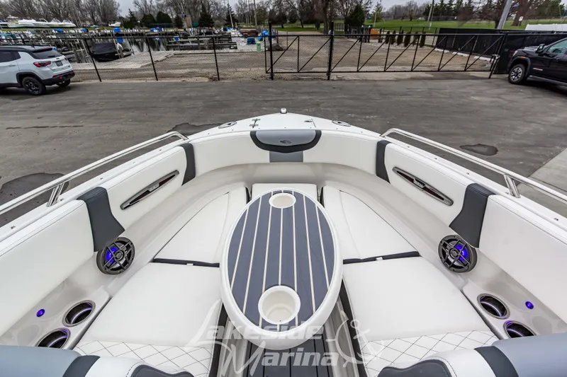 Slide: The Image of 2026 Chaparral SSX 4 boat interior with luxurious seating and modern design at a marina. - 26