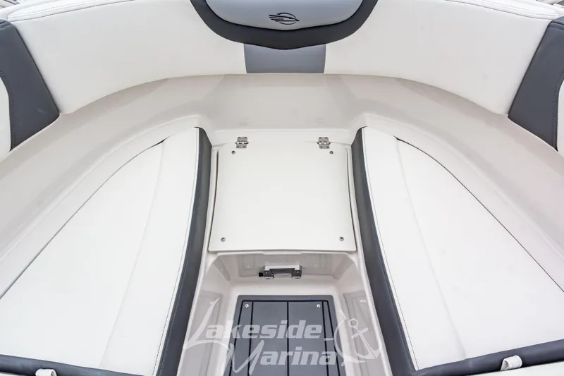 Slide: The Image of 2026 Chaparral SSX 4 boat interior with white and gray seating, storage compartment. - 29