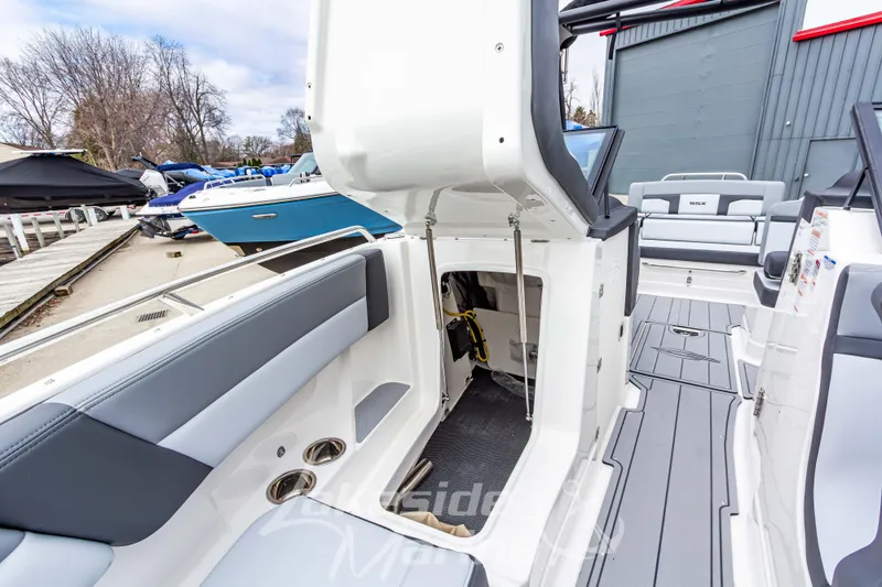 Slide: The Image of 2026 Chaparral SSX 4 boat interior with open storage compartment and sleek seating. - 34