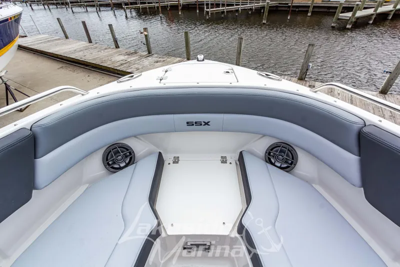 Slide: The Image of 2026 Chaparral SSX 4 boat interior with gray seating and speakers at a dock. - 36