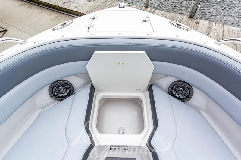 Slide: The Image of 2026 Chaparral SSX 4 boat interior with storage compartment and speakers, dockside view. - 37
