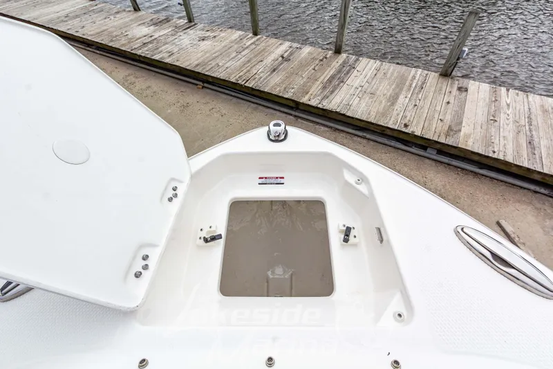 Slide: The Image of Open storage compartment on 2026 Chaparral SSX 4 boat near wooden dock. - 38