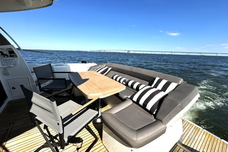 Slide: The Image of Prestige 500S 2016 yacht deck with seating, table, and ocean view. - 10