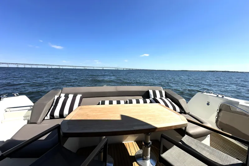 Slide: The Image of Luxurious 2016 Prestige 500S yacht with elegant seating, ocean view, and clear blue sky. - 11