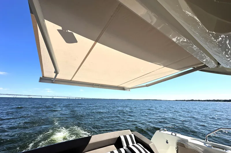 Slide: The Image of 2016 Prestige 500S yacht with awning, cruising on open water under clear blue sky. - 12