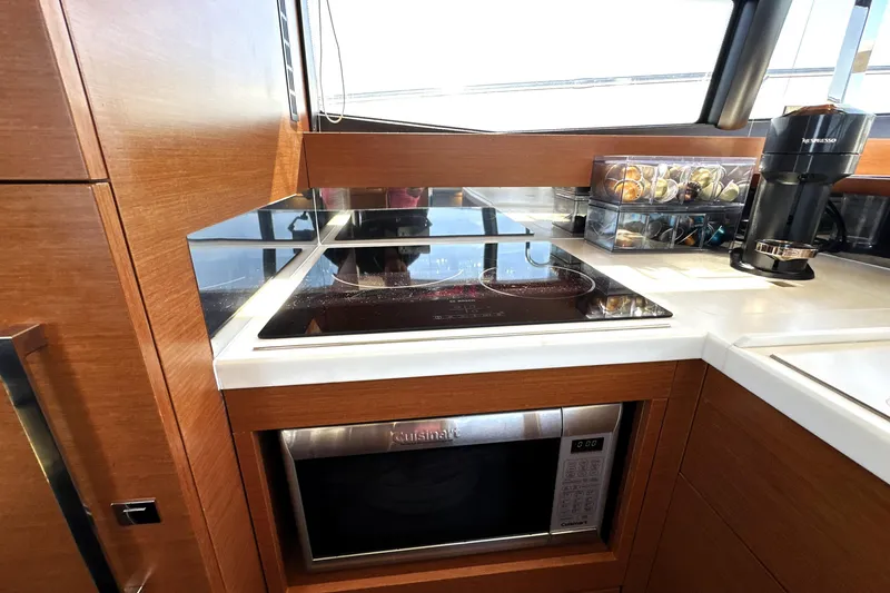 Slide: The Image of Modern kitchen in 2016 Prestige 500S yacht with stove, microwave, and coffee maker. - 18
