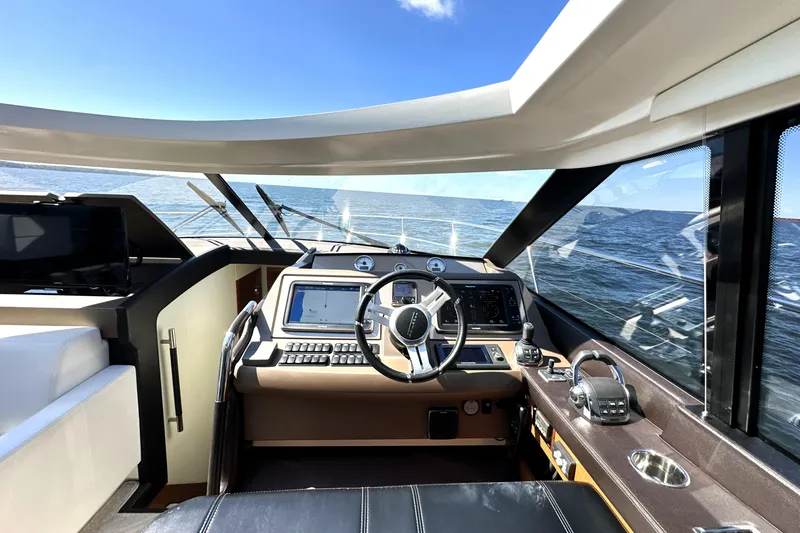 Slide: The Image of Interior view of 2016 Prestige 500S yacht helm with ocean backdrop. - 25