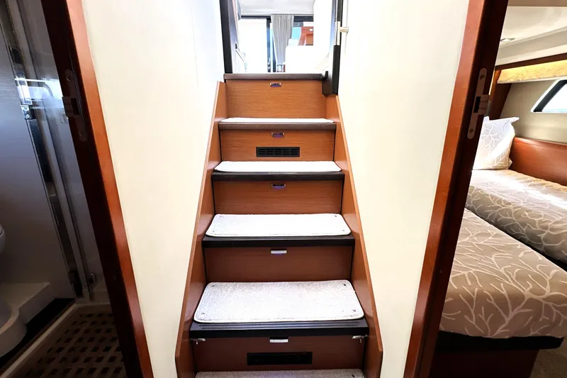 Slide: The Image of Staircase inside 2016 Prestige 500S yacht, leading to luxurious cabin area. - 39