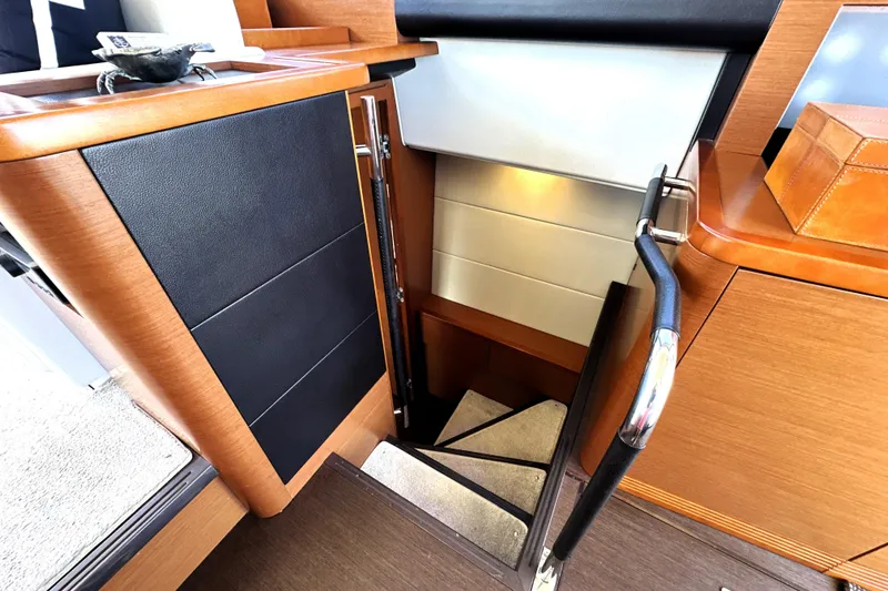 Slide: The Image of Staircase inside 2016 Prestige 500S yacht with modern wood and leather design. - 41