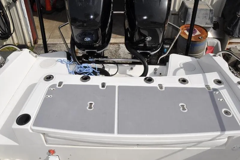 Slide: The Image of 2016 Boston Whaler 270 Dauntless boat with dual outboard engines and deck storage. - 11