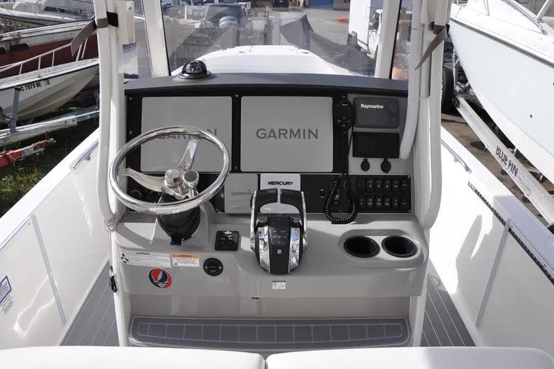 Slide: The Image of 2016 Boston Whaler 270 Dauntless helm with Garmin navigation and Mercury controls. - 16
