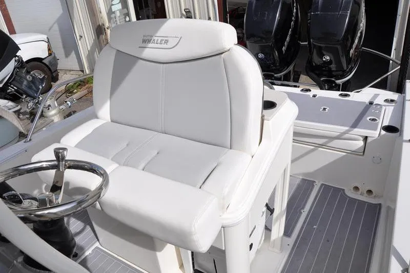 Slide: The Image of 2016 Boston Whaler 270 Dauntless boat interior with steering wheel and seating. - 17