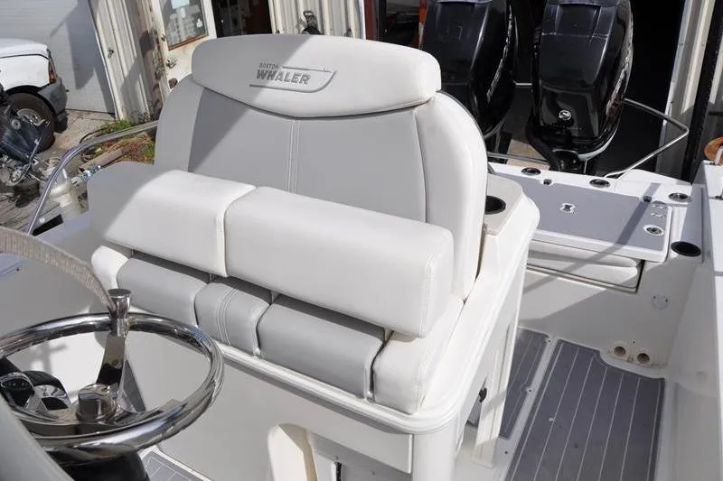 Slide: The Image of 2016 Boston Whaler 270 Dauntless boat interior with steering wheel and seating. - 18