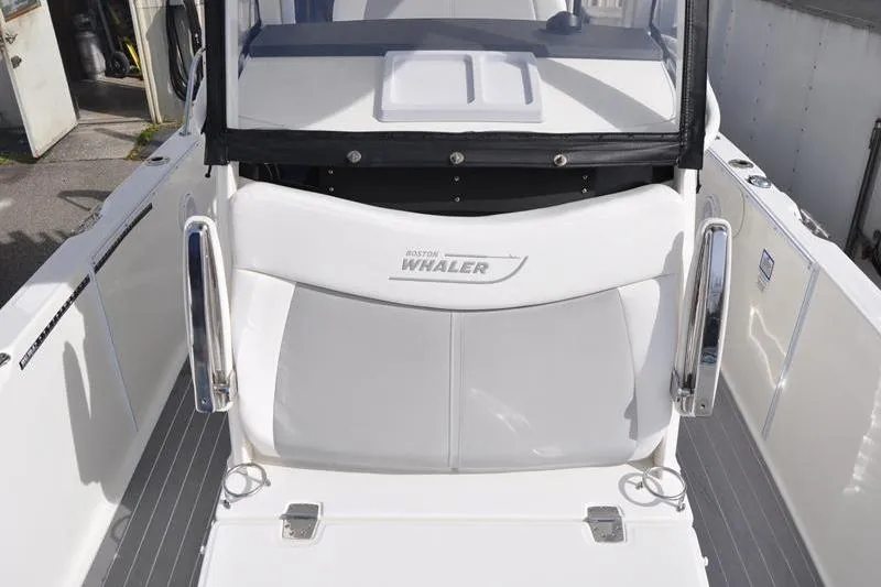 Slide: The Image of 2016 Boston Whaler 270 Dauntless boat interior with seating and chrome details. - 27