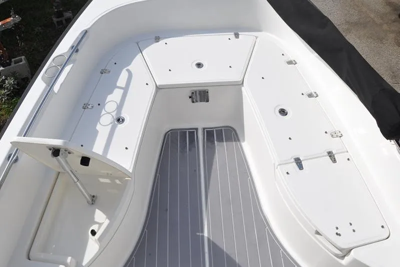 Slide: The Image of 2016 Boston Whaler 270 Dauntless boat interior with storage compartments and seating area. - 29