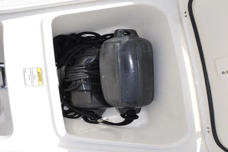 Slide: The Image of Storage compartment with fenders and ropes on a 2016 Boston Whaler 270 Dauntless boat. - 31