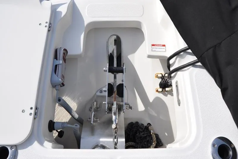 Slide: The Image of Anchor compartment of 2016 Boston Whaler 270 Dauntless boat, featuring chain and rope storage. - 33