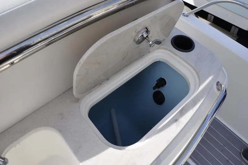 Slide: The Image of Open storage compartment on 2016 Boston Whaler 270 Dauntless boat deck. - 37