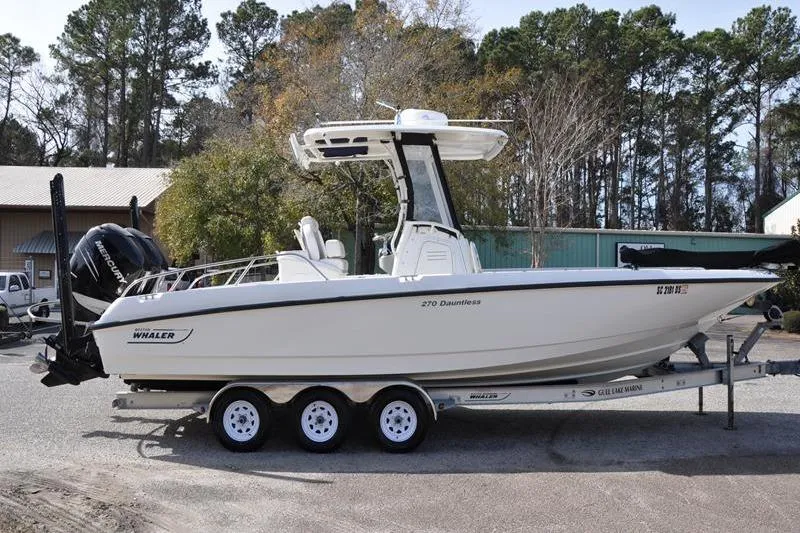 Slide: The Image of 2016 Boston Whaler 270 Dauntless boat on trailer, parked outdoors. - 5