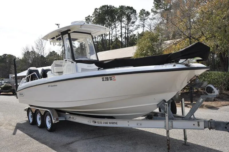 Slide: The Image of 2016 Boston Whaler 270 Dauntless boat on trailer, parked outdoors. - 6