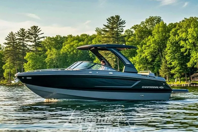 The Image of 2026 Chaparral SSX 6 boat cruising on a scenic lake with lush green trees. - 0