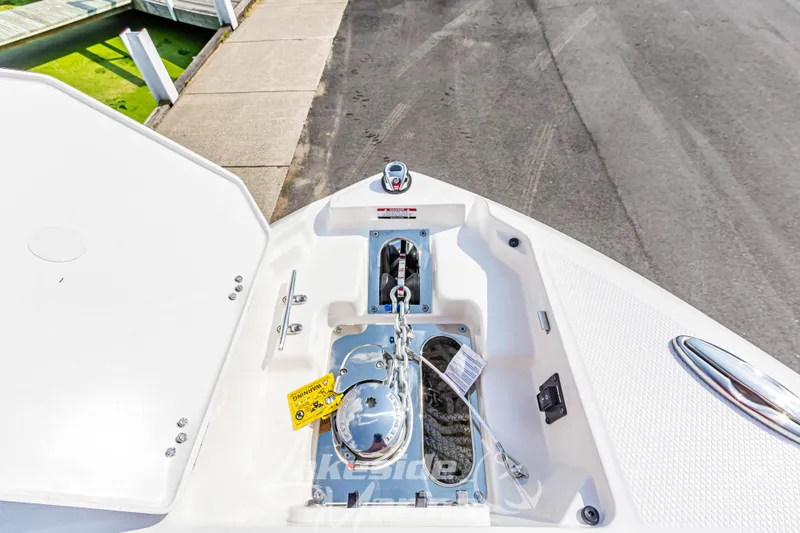 Slide: The Image of 2026 Chaparral SSX 6 boat anchor compartment with open hatch, dockside view. - 37
