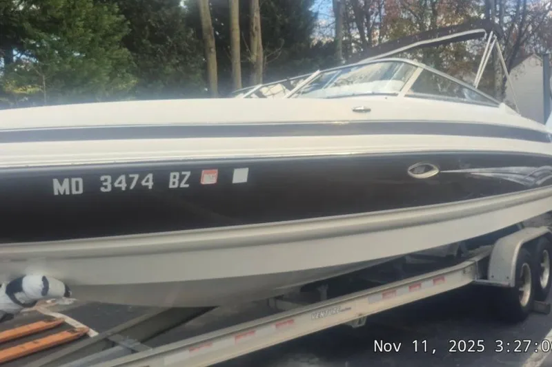 The Image of 2008 Larson LXi 268 boat on trailer, registration MD 3474 BZ, parked outdoors. - 1