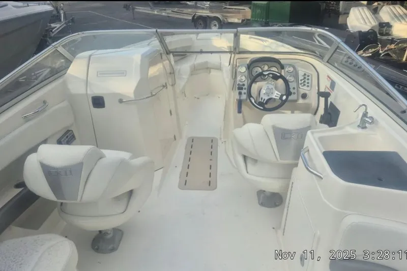 Slide: The Image of 2008 Larson LXi 268 boat interior with steering wheel and seating arrangement. - 3