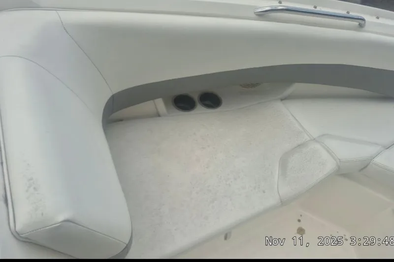 Slide: The Image of 2008 Larson LXi 268 boat interior with white seating and cup holders. - 6