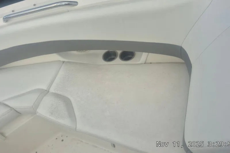 Slide: The Image of 2008 Larson LXi 268 boat interior with white seating and cup holders. - 8